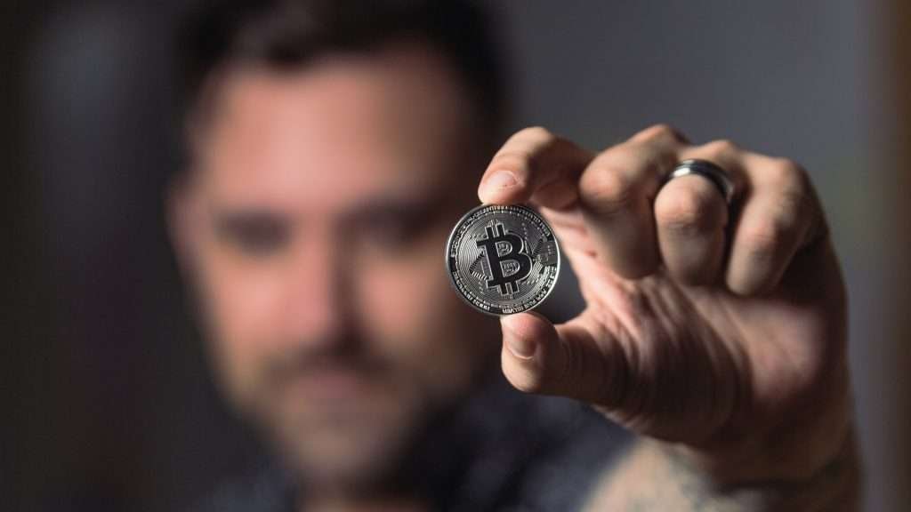 man is holding bitcoin